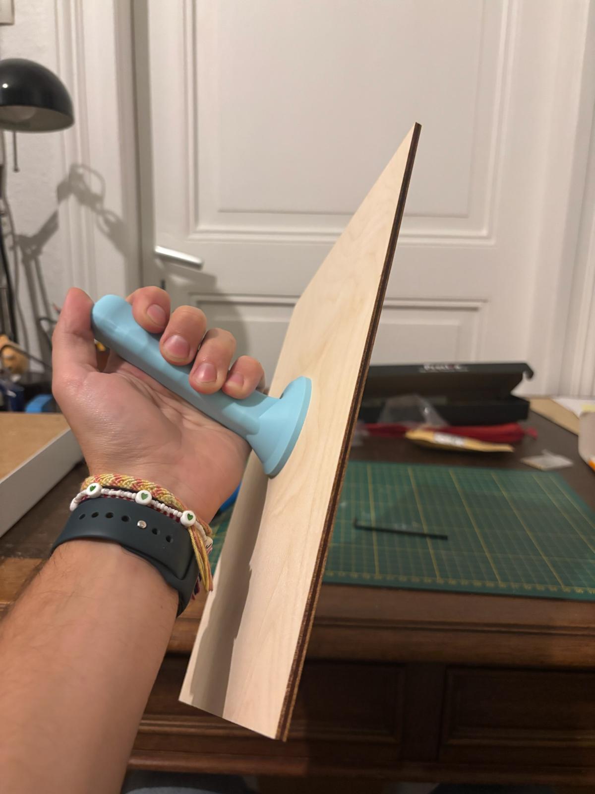 Poignée bleue fixée sur une planche en bois